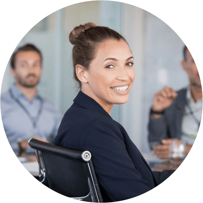 A woman sitting in a chair with other people behind her.