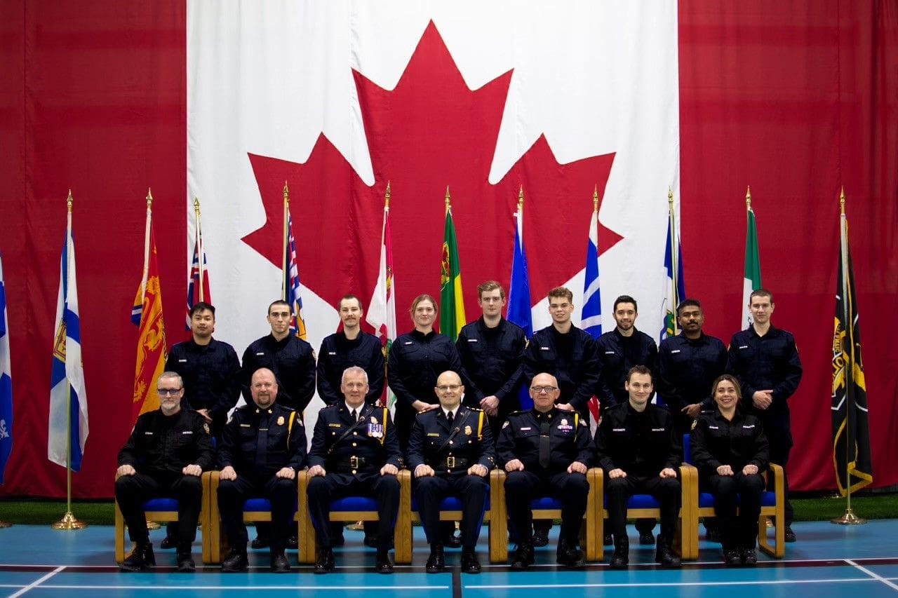 A group of men in uniform sitting next to each other.