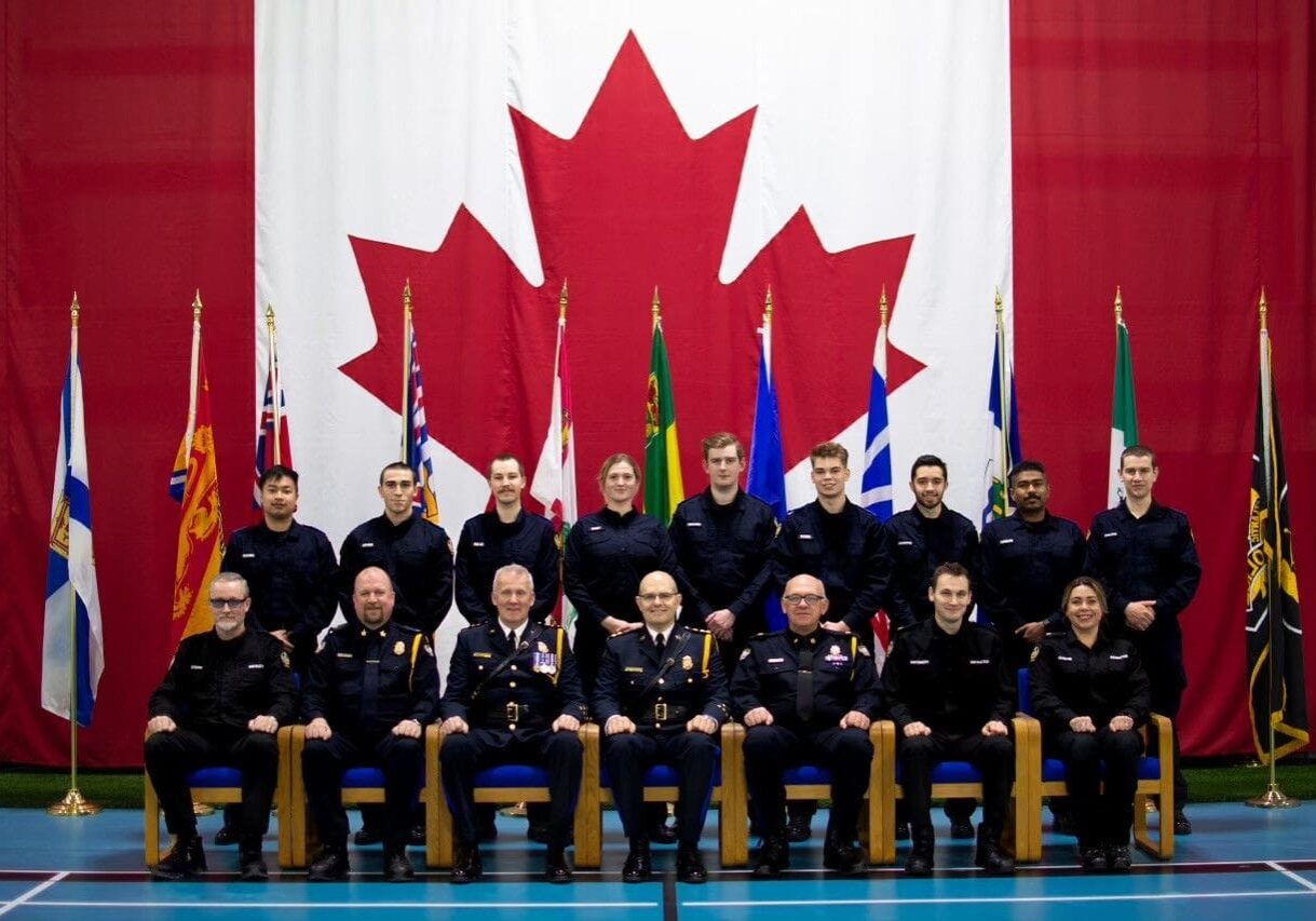 A group of men in uniform sitting next to each other.